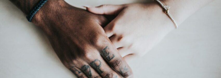 Couples holding hands during prison visit