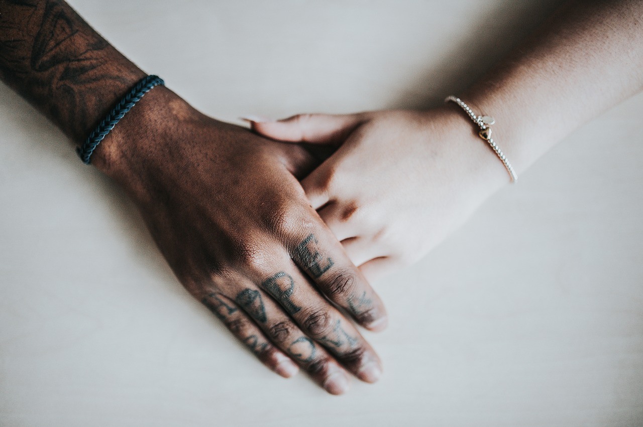 Couples holding hands during prison visit