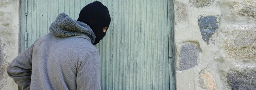 A burglar breaking into a house in California.