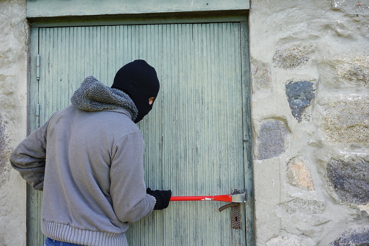 A burglar breaking into a house in California.