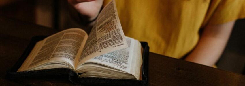 An inmate reading a bible in prison.