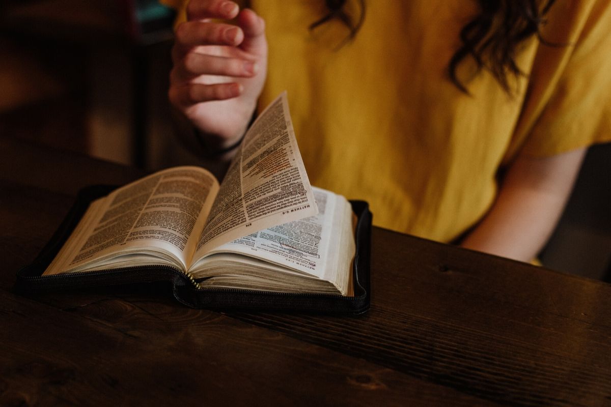 An inmate reading a bible in prison.