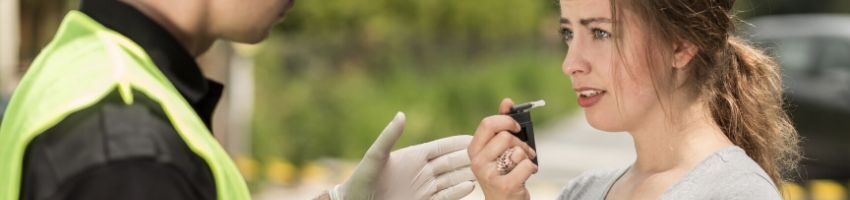 A woman getting tested for alcohol levels.