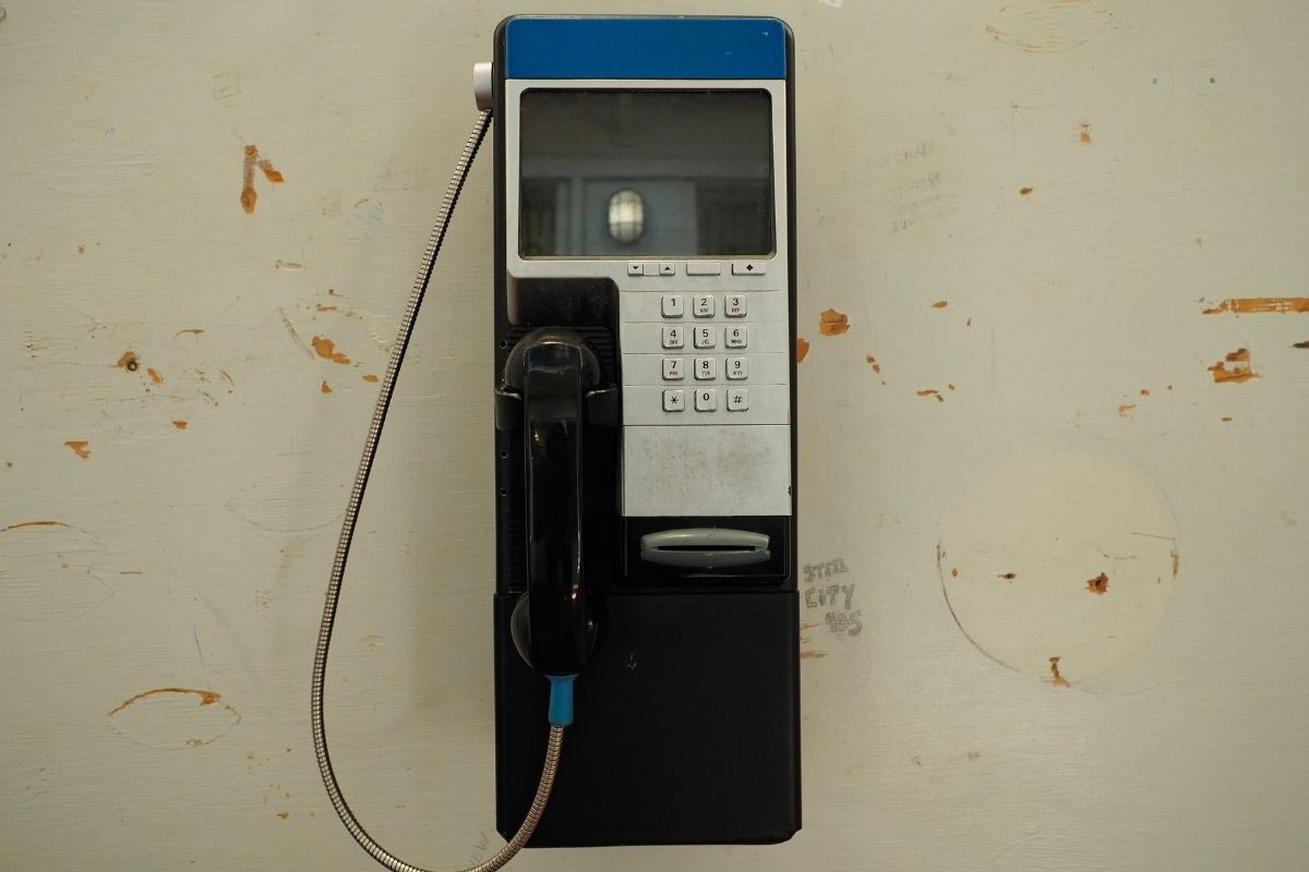 A prison phone where inmates put money to make a call.