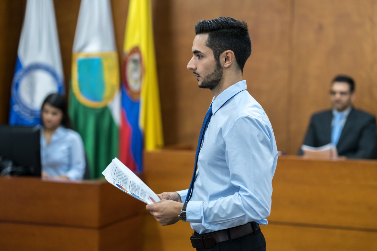 A man reading something in front of a jury.