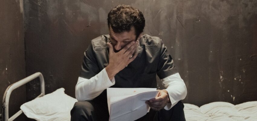 An inmate cries as he reads a parole support letter he wrote.