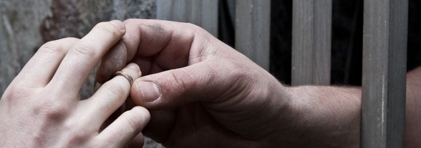 A prisoner giving a promise ring to his loved one.