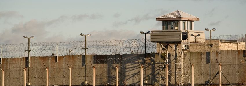 An inmate holding on to the prison bars.