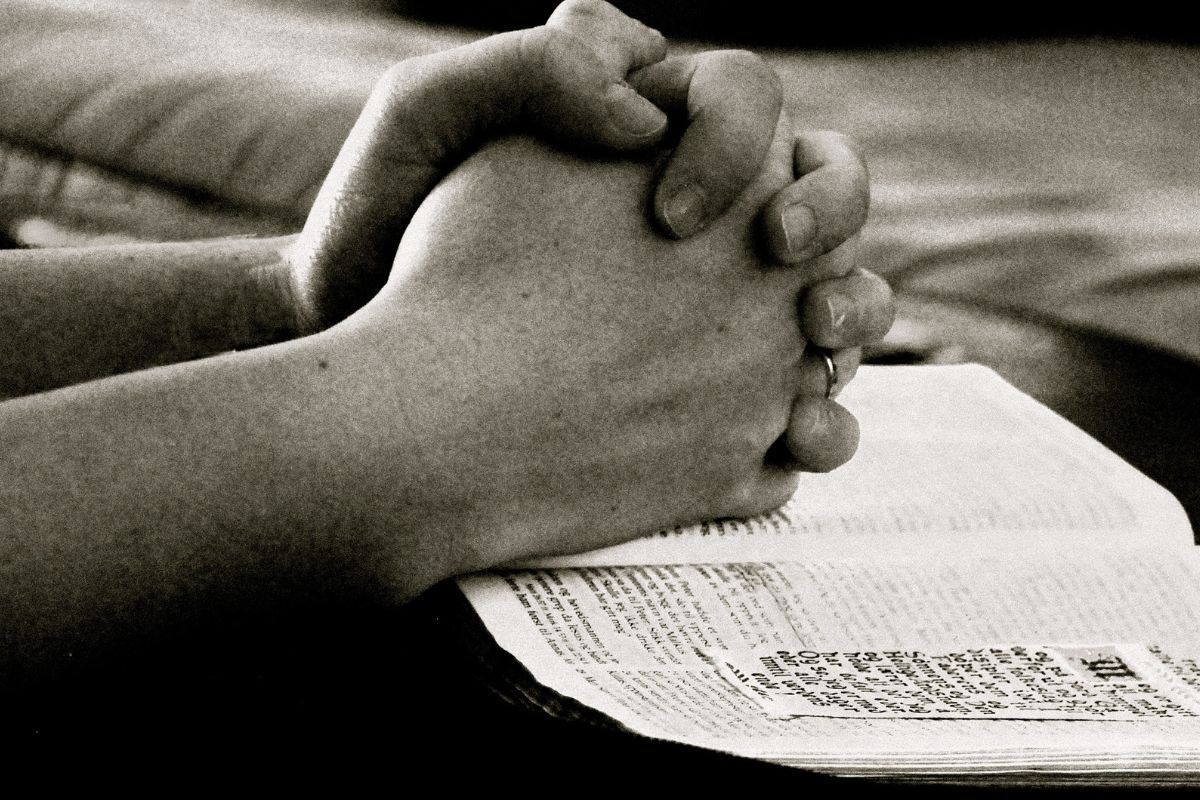 The inmate is reading encouraging bible verses.