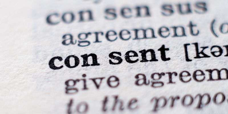 A photo of words in a dictionary highlighting the word consent